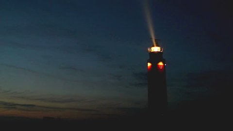 Fast forward lighthouse with turning light beam at the island of Texel in The Netherlands.
