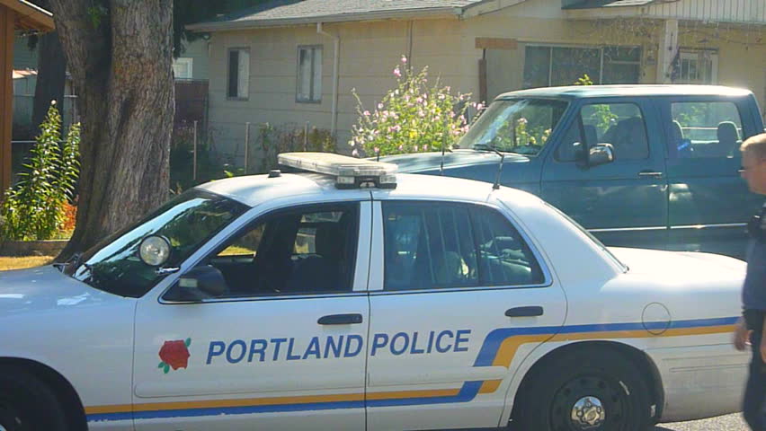 PORTLAND, OREGON - CIRCA AUGUST 2011: Police car parked with police officer