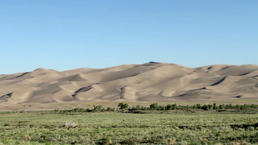 Smooth vehicle footage driving by The Great Sand Dunes National Park in Southern