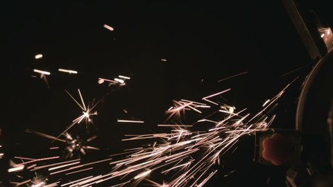 Closeup of grindstone grinding metal spraying sparks