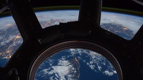 Earth as seen through window of International Space Station (ISS). Perfect of computer graphics videos about: space, earth, orbit, ISS, the International Space Station, astronauts, NASA and discovery