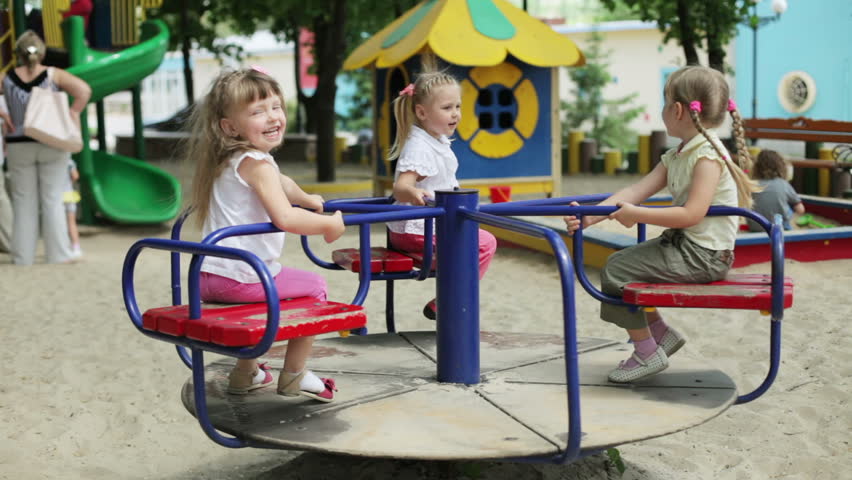 Children wave their hands on the carousel, and clap their hands