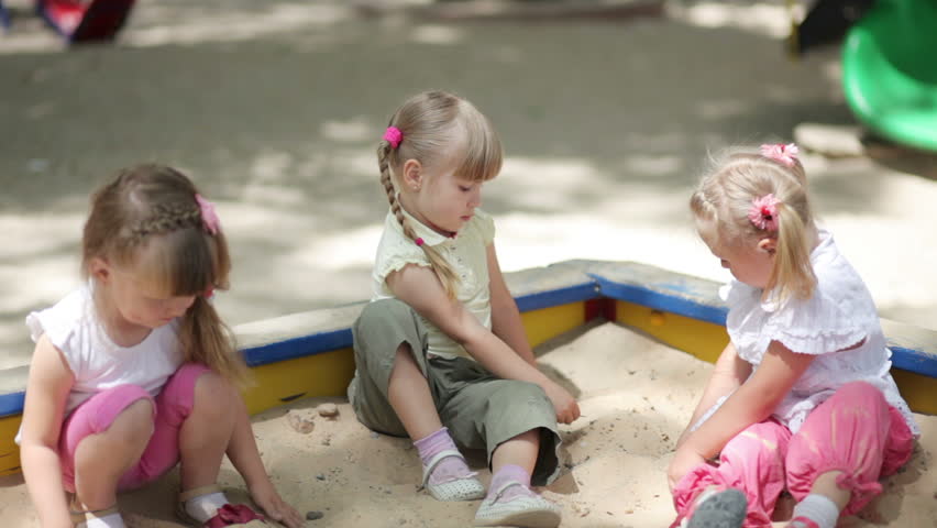 Young girls playing in the sandbox