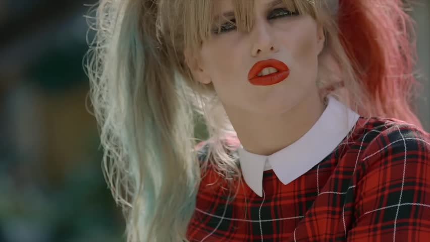 Sexy woman with finger on her red lips showing hush.