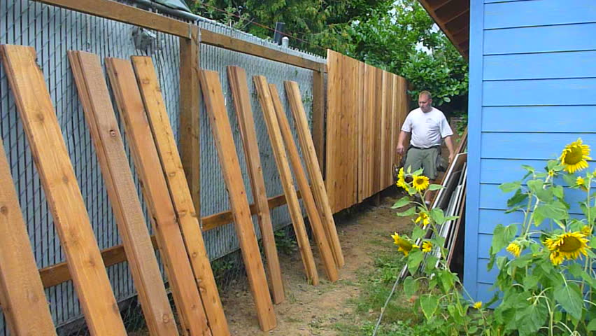 PORTLAND, OREGON - CIRCA JANUARY 2011: Man building new cedar fence series time