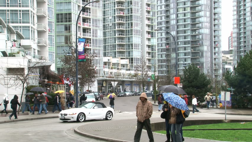 VANCOUVER, BRITISH COLOMBIA - CIRCA 2010: Busy intersection and high rise