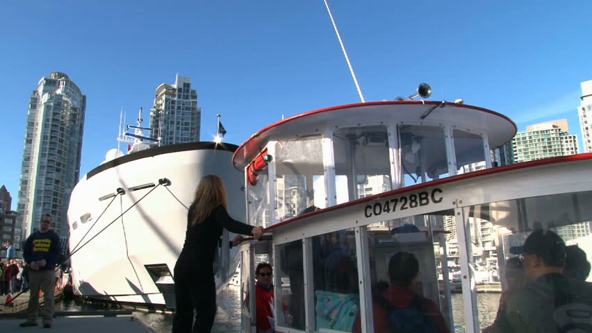 VANCOUVER, BRITISH COLOMBIA - CIRCA APRIL 2010: People entering water ferry in