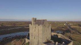 Aerial View Epic Dunguaire Castle Evening Sunset, near Kinvarra in County Galway, Ireland - Wild Atlantic Way Route. Famous public tourist attraction in Ireland. Flat video profile