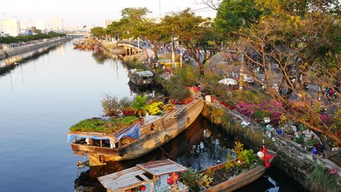 Ho Chi Minh city , Vietnam - February 5th, 2016: Boating along canal carry flowers with apricot, confetti, almond tree to sell everyone distillation welcome spring Tet in Ho Chi Minh City, Vietnam