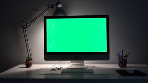 big beautiful computer with a lamp on a green background