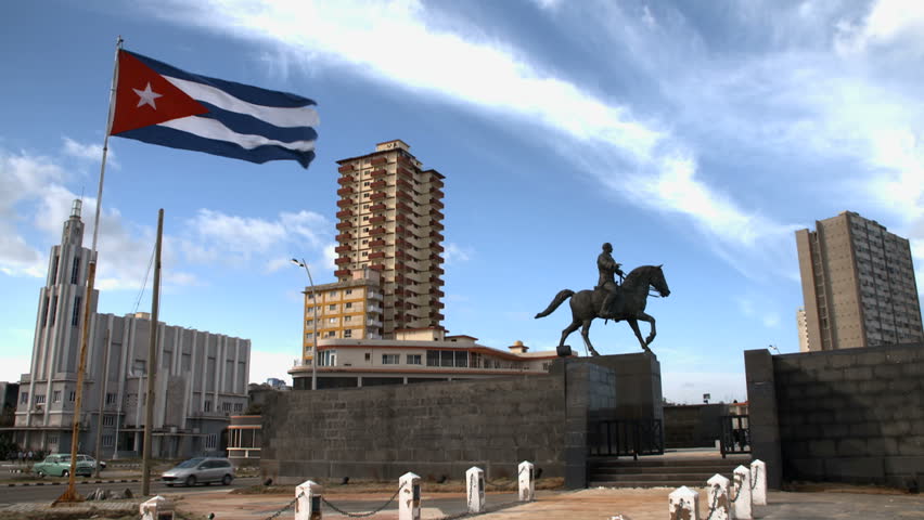 cuban flag, statue, and downtown skyline in Havana, Cuba