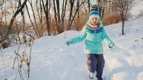 Carefree child trips out on snow-covered path
