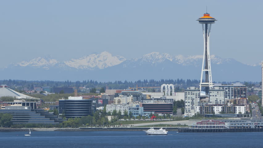 Timelapse of Seattle Space Needle with Mountains in the Background. Space Needle