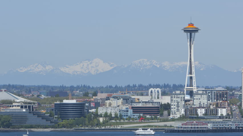 Timelapse of Seattle Space Needle with Mountains in the Background. Space Needle
