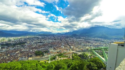 Picturesque aerial view of Grenoble city, France. Grenoble-Bastille cable car on the foreground. Time Lapse. 4K UltraHD