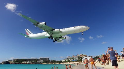 Simpson bay, Sint Maarten-January 18, 2017: Air France KLM Airbus A340-300 jet lands over a crowd of people at princess Juliana international airport on the Caribbean island of St.Maarten