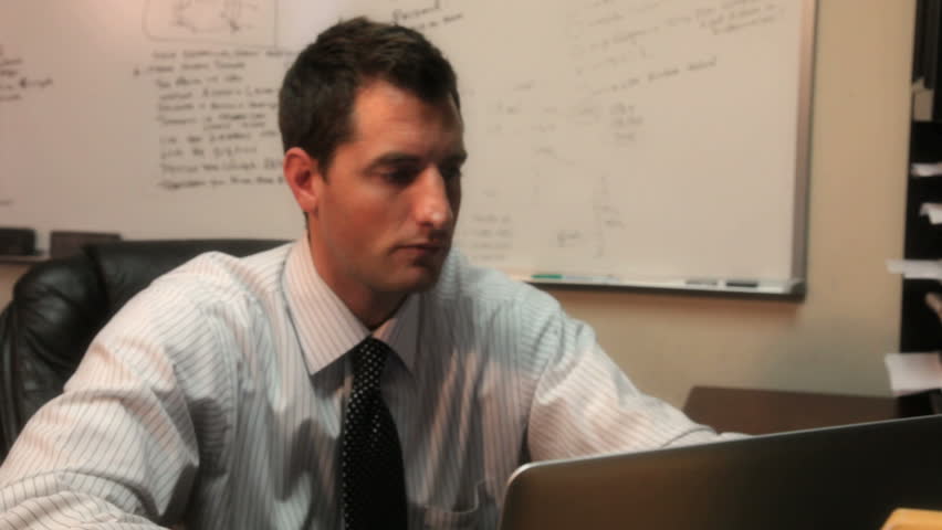 Business man takes a phone call in the office