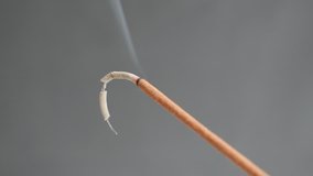 Smoke spreading from burned fragrant incense stick 4K 2160p 30fps UltraHD footage - Close-up of aromatic biotic material burning for meditation purpose 3840X2160 UHD video