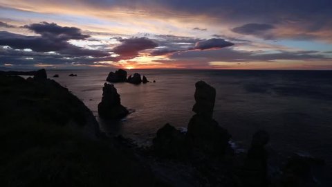 Sunset Atlantic Ocean rocky coastline view with colorful sky (Pielagos, Cantabria, Spain).

