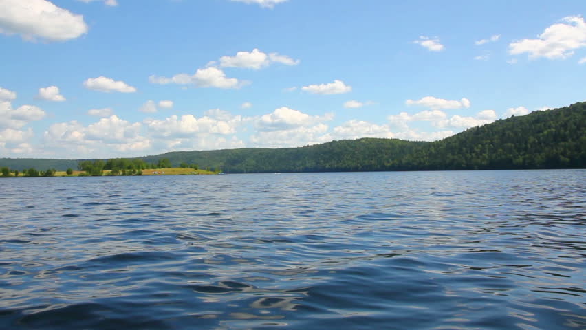 summer lake with waves under blue sky