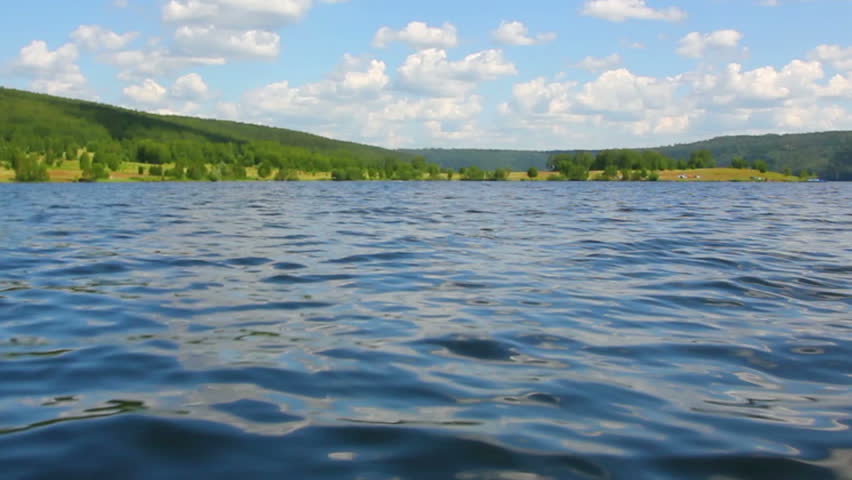 summer lake with waves under blue sky