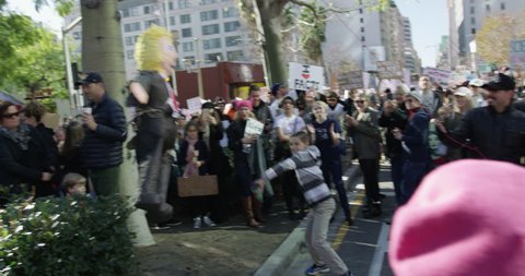 Women's March in Los Angeles, California. Over 500,000 people gathered in downtown Los Angeles. January 21, 2017. A young boy hitting a piñata that looks like Donald Trump.
