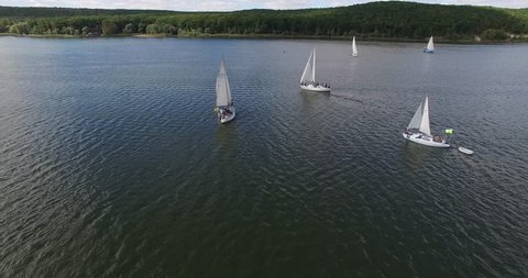 Sailing ship yachts on a lake. Aerial view: Sailboats floating on a lake