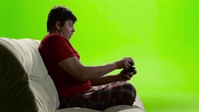 Gamer man intently playing a video game. Green screen studio