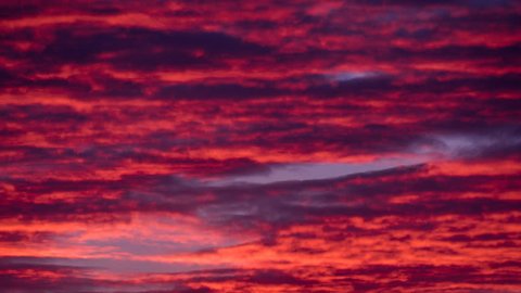 Red purple violet pastel sky timelapse. Cirrus stratus cumulus cloud scape. Aero ozone airy wispy cloud fast motion time lapse. Day night sunset sky clouds movement. Fantastinc majestic dramatic sky