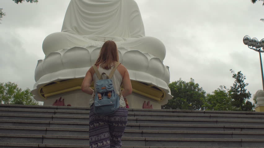 Young woman on a stairs to Big Budha in LongSon Pagoda. Nhga Trang. Vietnam