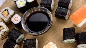 Sushi rotating on a wooden plate (not loopable; 4K)