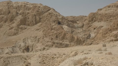 panning view of the hills and caves containing the dead sea scrolls at qumran in israel