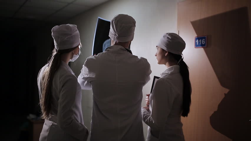 Healthcare, medical: Group of multi-ethnic doctors discuss and looking x-ray in a clinic or hospital