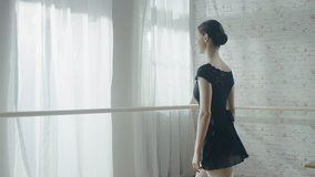 Young and Beautiful Ballerina Dances at the Barre. Shot on Warm and Sunny Morning in a Spacious and Modern Studio.  Shot on RED EPIC-W 8K Helium Cinema Camera. - Powered by Shutterstock - Get 15% off with code: PIKWIZARD15