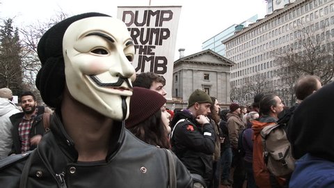 PORTLAND, OREGON - CIRCA 2017: Anonymous masked man attends an anti Donald Trump rally on inauguration day in Portland, Oregon.