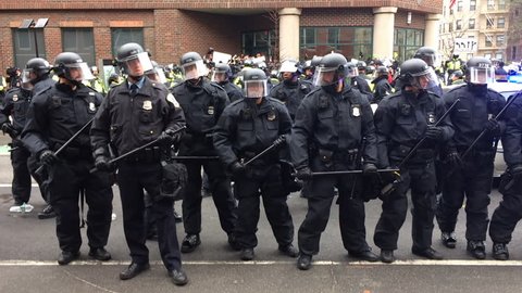 WASHINGTON, Jan. 20, 2017 -- Police in riot gear with batons and helmets form a line surrounding detained #DisruptJ20 protesters during the presidential inauguration of Donald Trump.