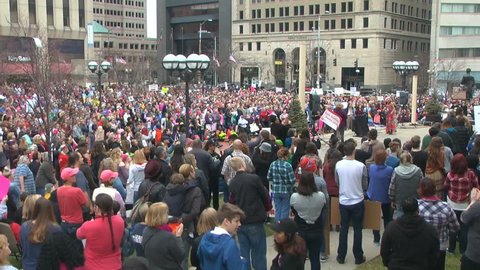 DAYTON, OHIO, USA - JANUARY 21, 2017: Women's March on Washington sister march in Ohio  shows a wide shot of the crowd reaction to a speaker including the charge "We are in the age of the daughters."