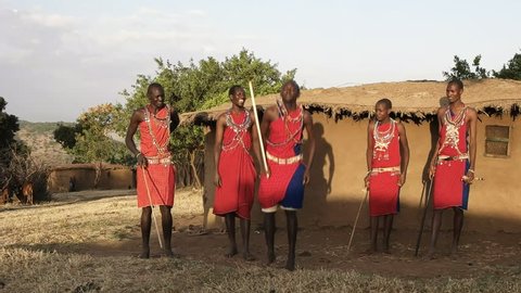 60p wide shot of five maasai warriors dancing at a village near masai mara- originally recorded at 120fps