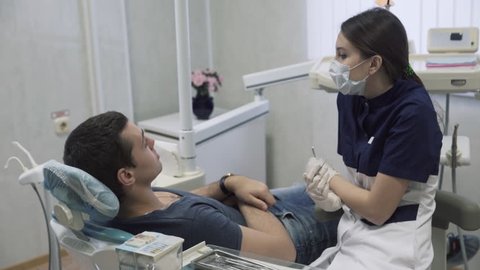 Dentist young woman examining male patient at dental office. Concept of healthy life
