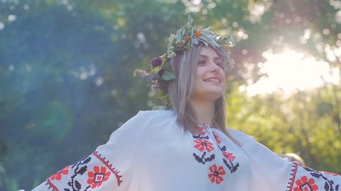 A group of young people in national Slavic costumes dance in a circle around the fire. National Slavic rites and dances in Slow motion. Midsummer. Arkistovideo