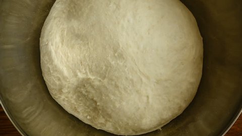 Closeup 4k video of yeast dough increases, time lapse