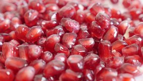 Red seeds of Lythraceae family pomegranate close-up 4K 3840X2160 UHD panning video - Healthy Punica granatum fruit peeled slow pan 2160p UltraHD footage