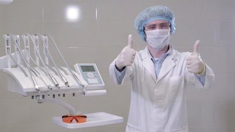 Dentist man doctor wearing medical gloves in clinic cabinet, modern hospital.