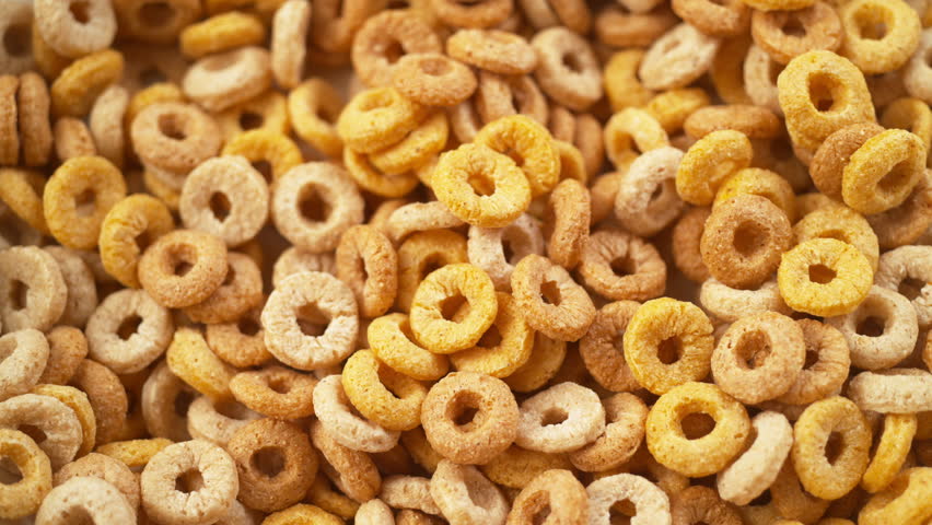 Milk being poured over cereal. 