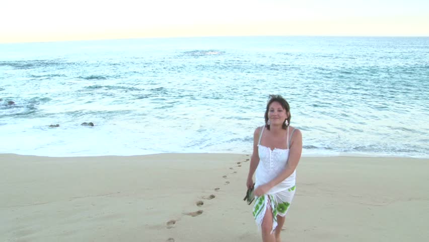 Woman walking on the coast of Cabo San Lucas, Mexico.