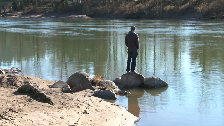 Man walks up to river's edge in Oregon.