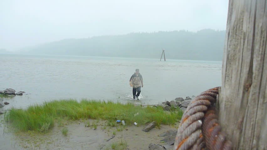 Man hikes, walking through Columbia River in Oregon and Washington around the