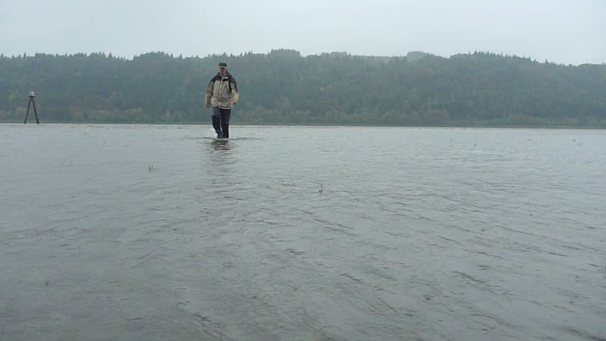 Man hikes, walking through Columbia River in Oregon and Washington around the