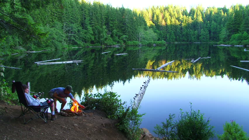 Time lapse of man and woman couple enjoying peaceful lake in Oregon. Man make