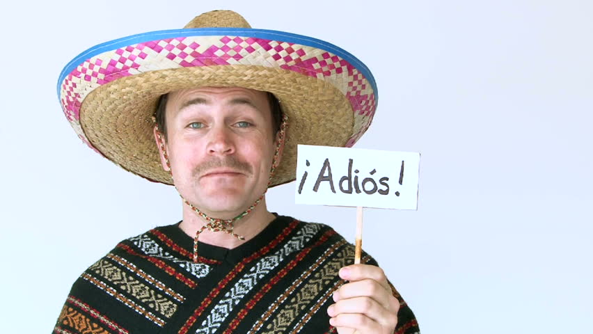 Man dressed in Mexican poncho and sombrero holds sign which reads Adios.